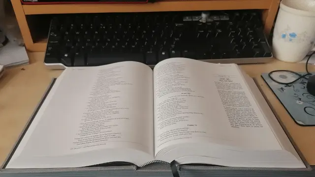 open bible placed on a study desk